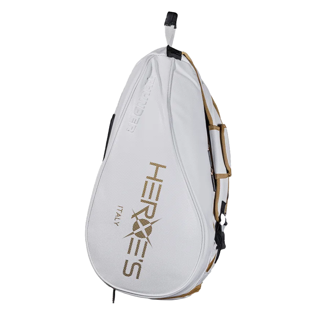 A white and gold Heroes brand duffle bag designed for beach tennis, with side compartment for a racket and thermal material lining.